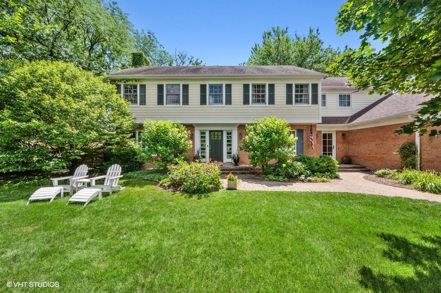 201 Summerfield Road Northbrook, IL 60062 - Photo 3 of 51 a front view of a house with a garden and sitting area