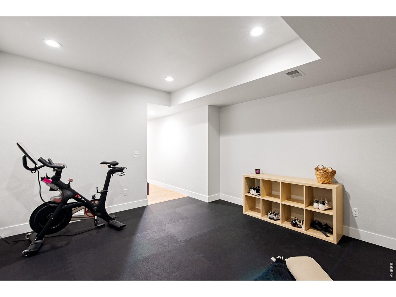 9421 Gunbarrel Ridge Road Boulder, CO 80301 - Photo 35 of 50 a room with wooden floor and gym equipment