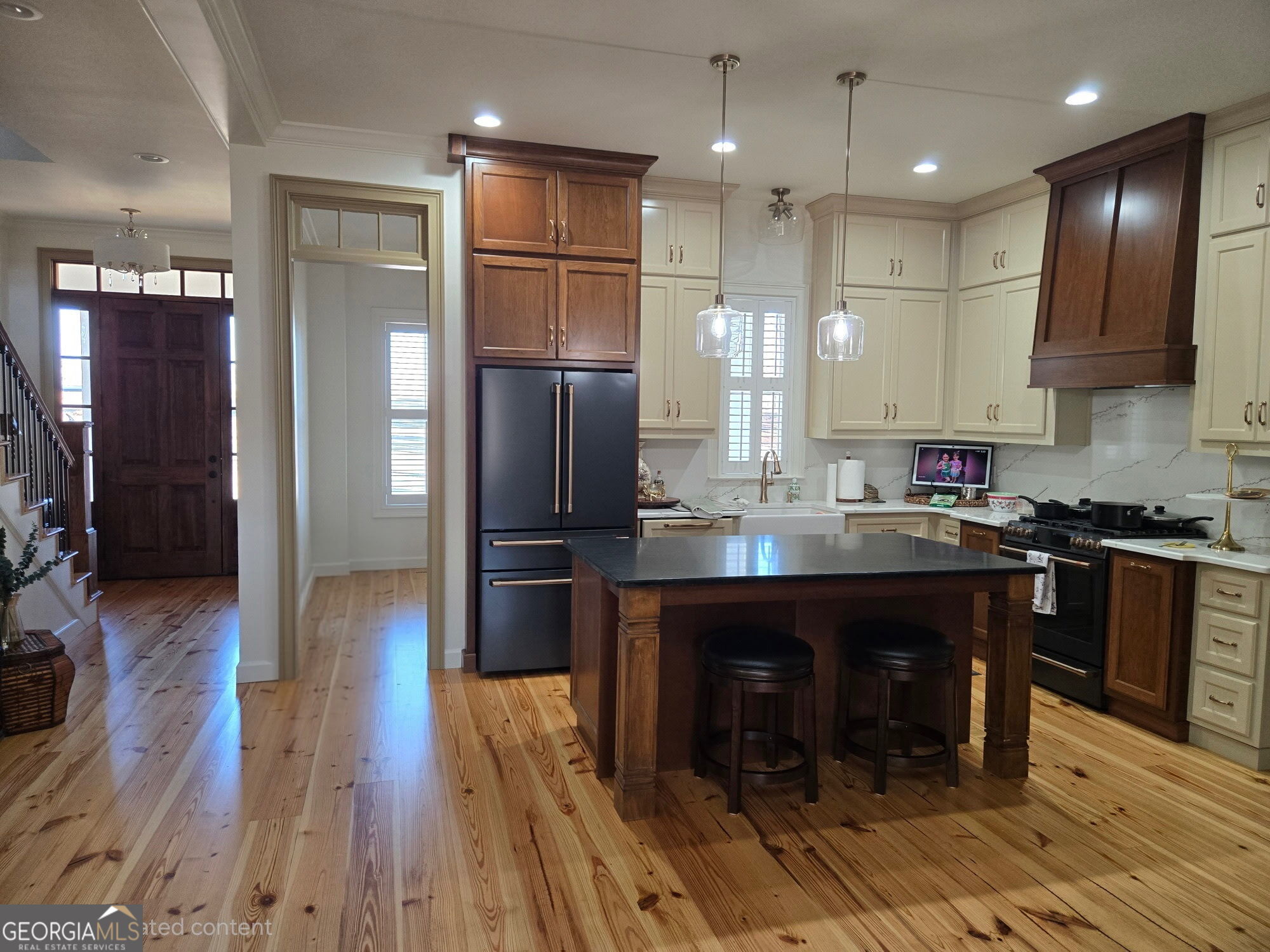 1065 Tarrytown Road Tarrytown, GA 30470 - Photo 24 of 130 a kitchen with kitchen island granite countertop wooden cabinets and refrigerator