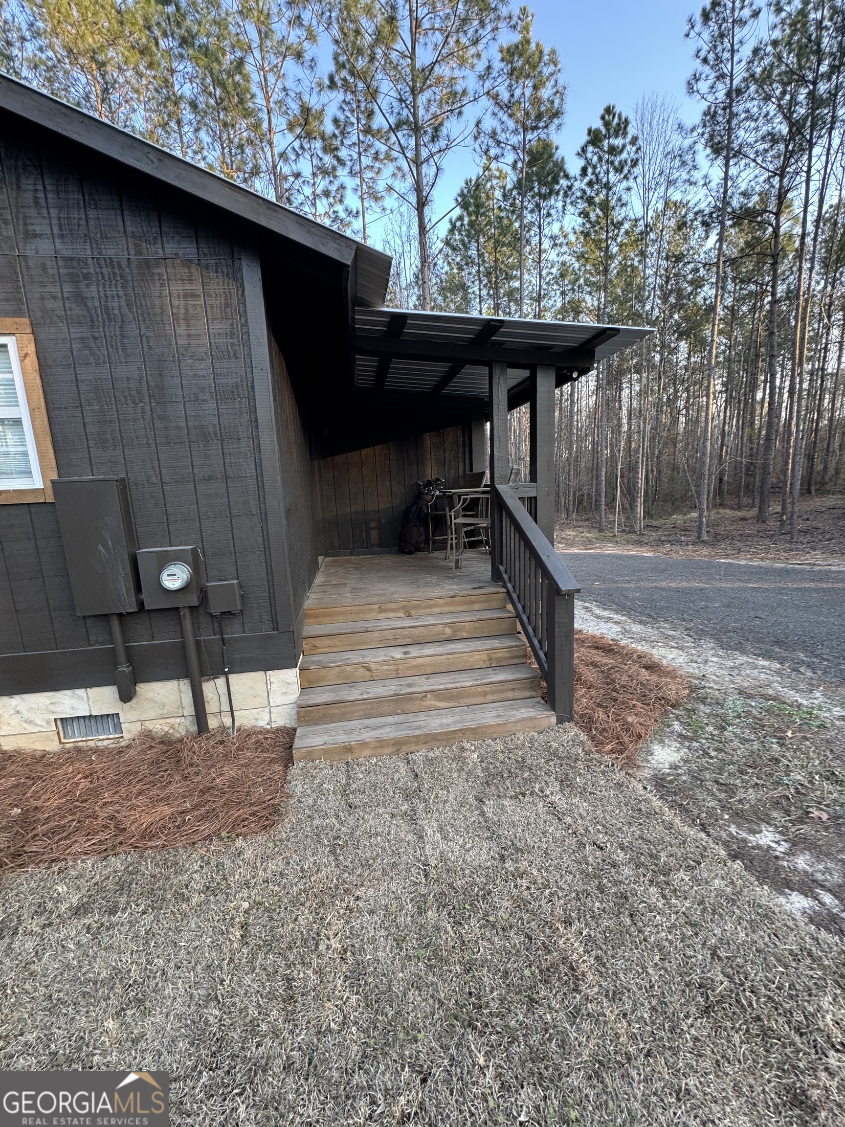 1065 Tarrytown Road Tarrytown, GA 30470 - Photo 74 of 130 a view of backyard with wooden fence and a bench