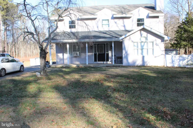 a front view of a building with a garden