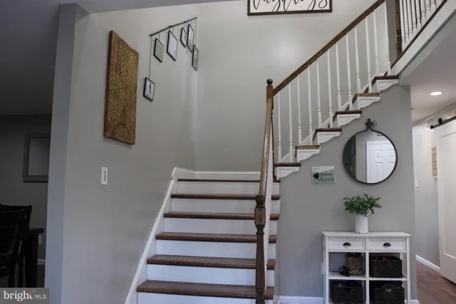 a view of entryway and hall with wooden floor