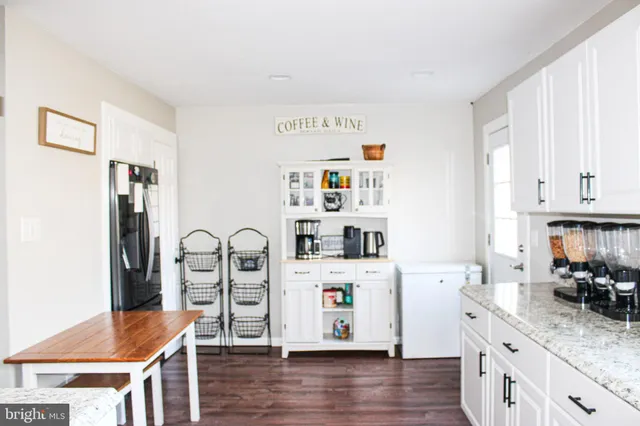 a kitchen with stainless steel appliances granite countertop a refrigerator sink and cabinets