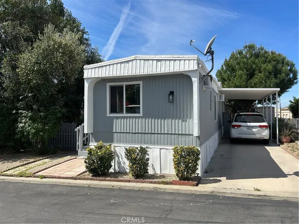 a view of a house with a small yard