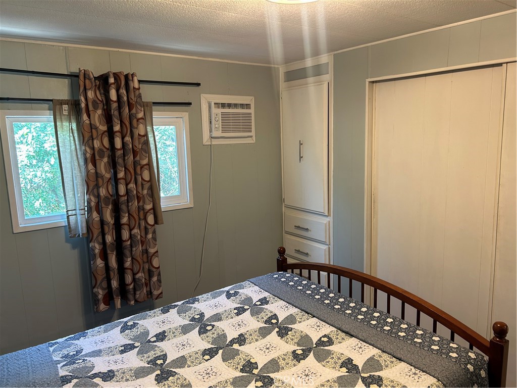 3734 Pacific Street, Unit 40 Highland, CA 92346 - Photo 12 of 35 a bedroom with a bed and wooden floor