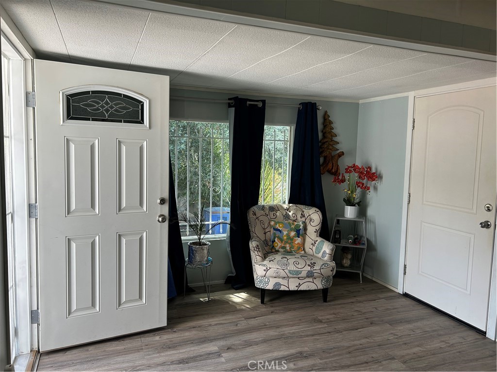 3734 Pacific Street, Unit 40 Highland, CA 92346 - Photo 17 of 35 a view of a livingroom with wooden floor and a ceiling fan