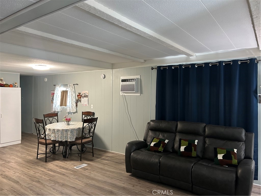3734 Pacific Street, Unit 40 Highland, CA 92346 - Photo 4 of 35 a living room with furniture and a wooden floor