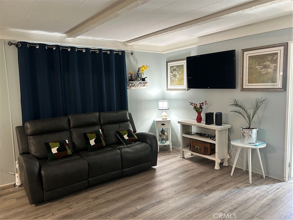 3734 Pacific Street, Unit 40 Highland, CA 92346 - Photo 5 of 35 a living room with furniture and a flat screen tv