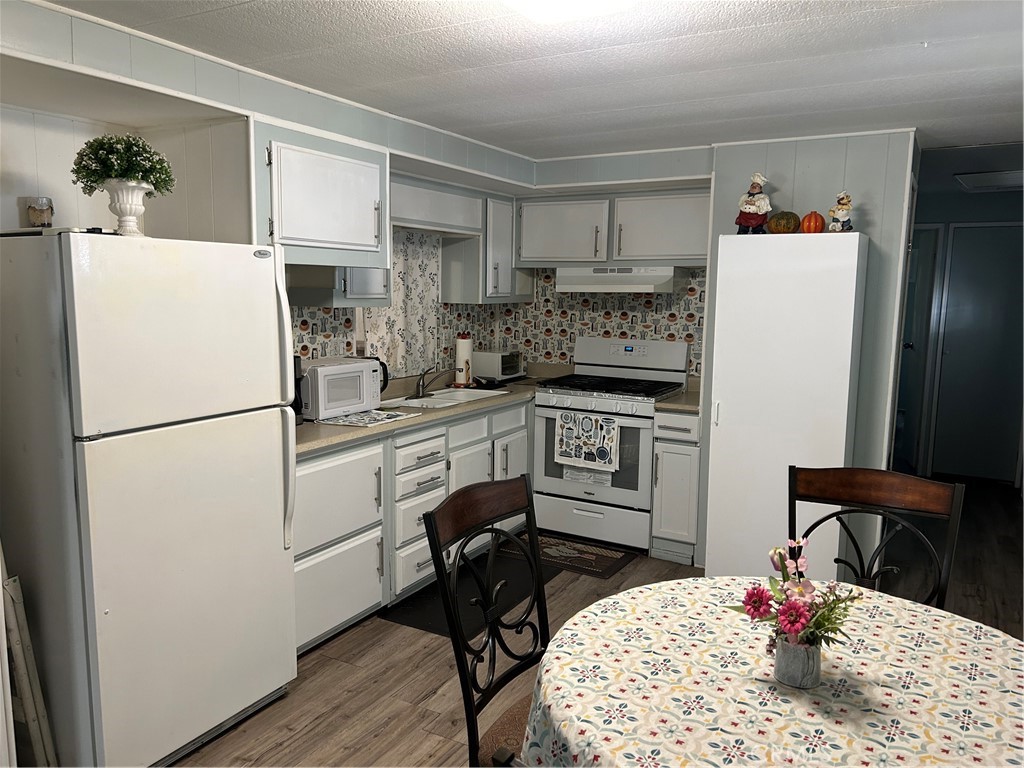 3734 Pacific Street, Unit 40 Highland, CA 92346 - Photo 9 of 35 a kitchen with a refrigerator and a stove top oven