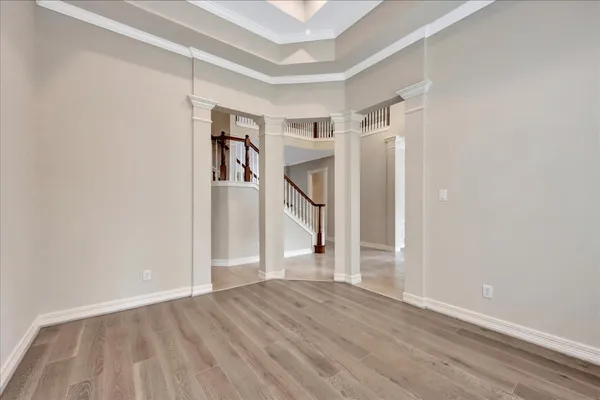 a view of empty room with wooden floor