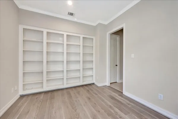 a view of wooden floor and windows in a room