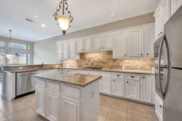 a kitchen with cabinets appliances and a center island