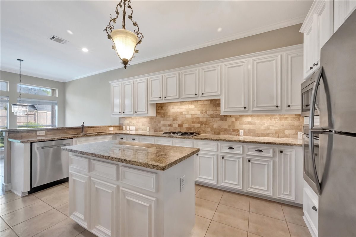15511 Turtle Oak Court Houston, TX 77059 - Photo 18 of 50 a kitchen with cabinets appliances and a center island