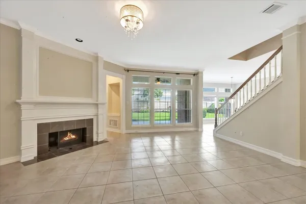 a view of an empty room with a fireplace and a window