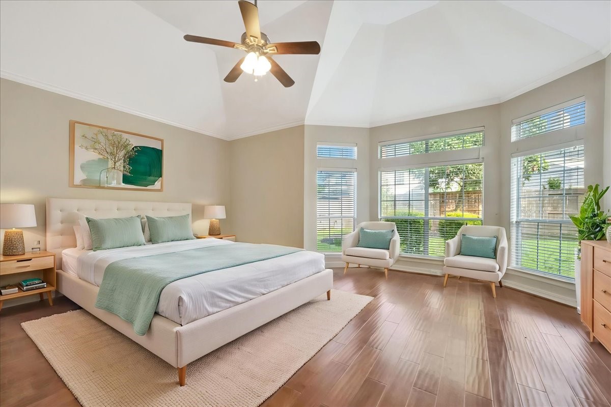 15511 Turtle Oak Court Houston, TX 77059 - Photo 29 of 50 a bedroom with a bed couch and a large window with wooden floor