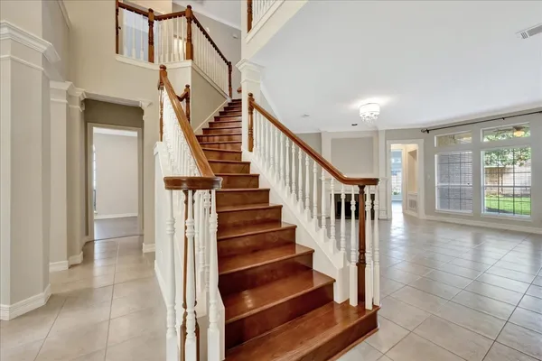 a room with pool table table and windows