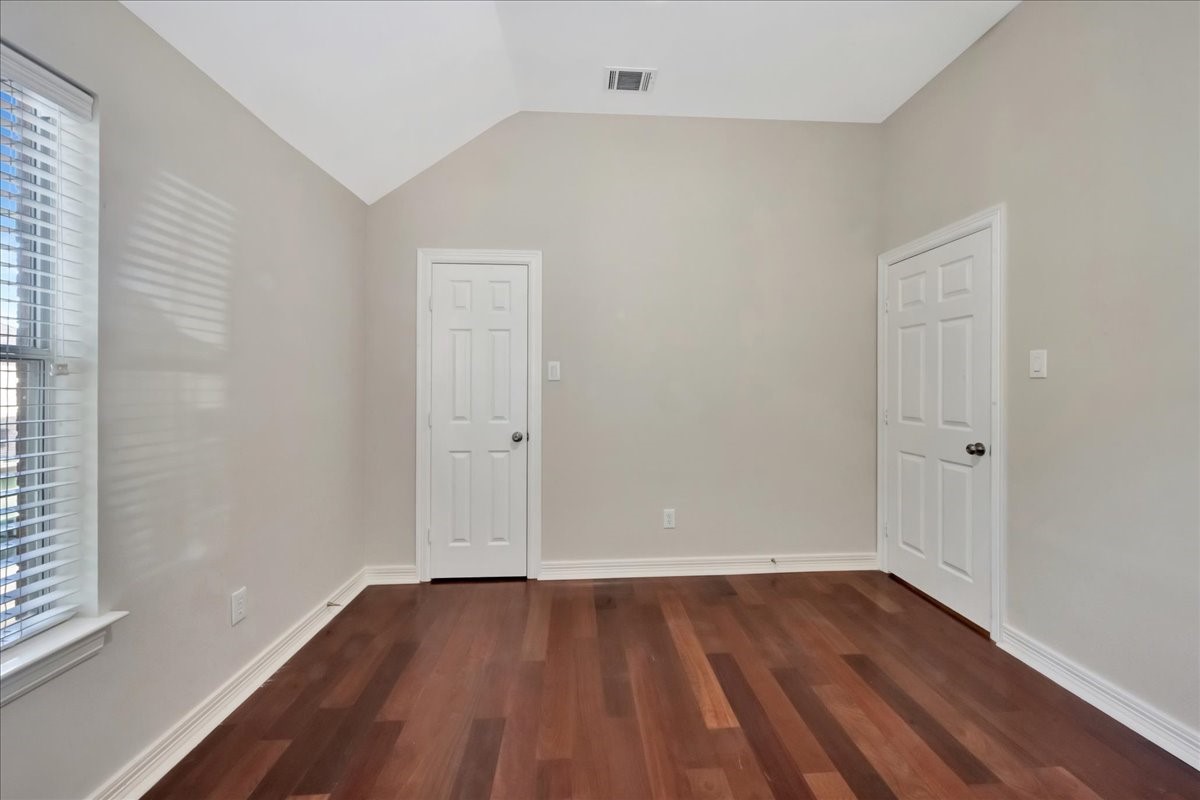 15511 Turtle Oak Court Houston, TX 77059 - Photo 43 of 50 a view of an empty room with wooden floor and a window