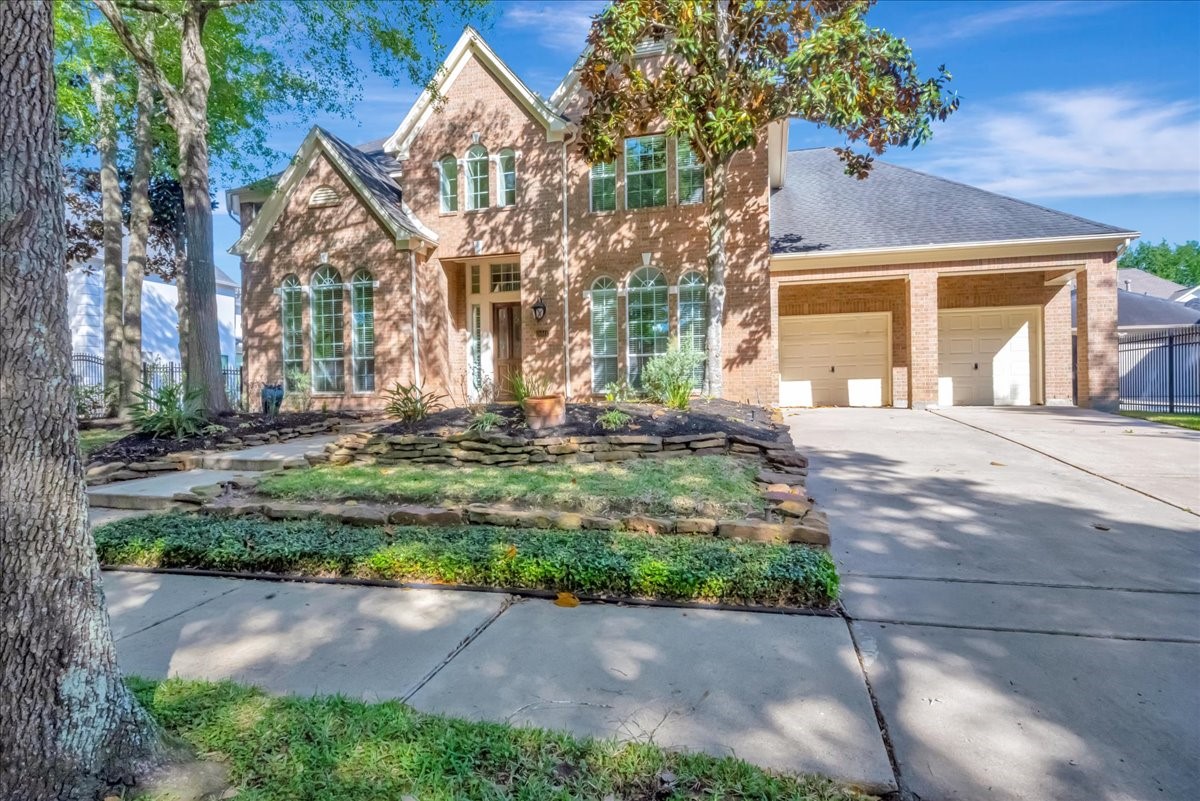 15511 Turtle Oak Court Houston, TX 77059 - Photo 50 of 50 a front view of a house with a yard and a garage