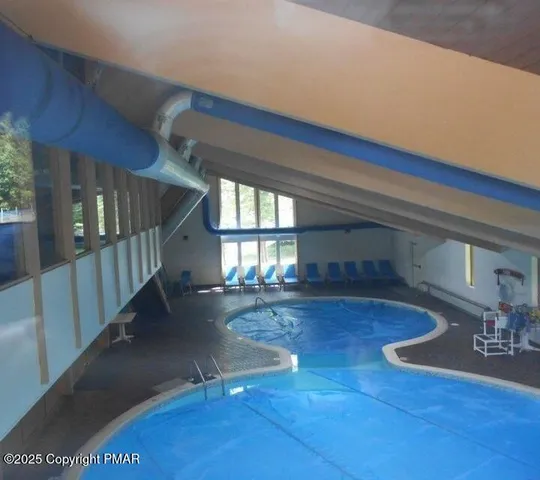 a view of swimming pool with lounge chair