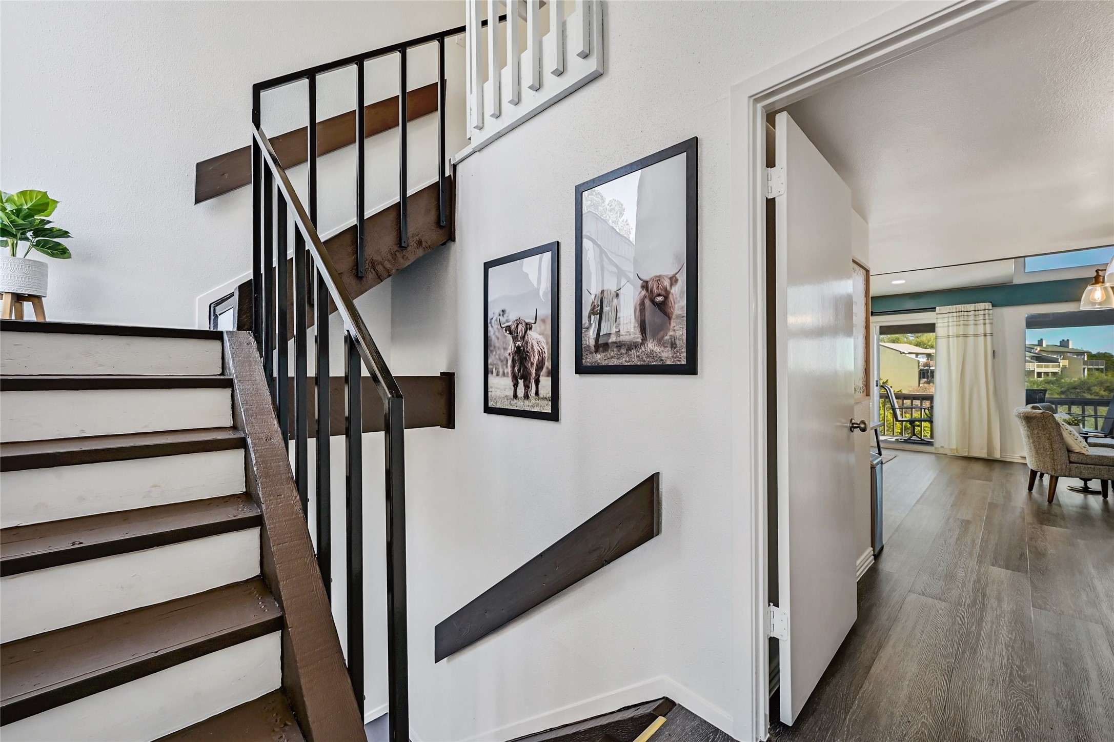 115 Comanche Drive Point Venture, TX 78645 - Photo 5 of 40 a view of staircase with lots of frames on wall and wooden floor