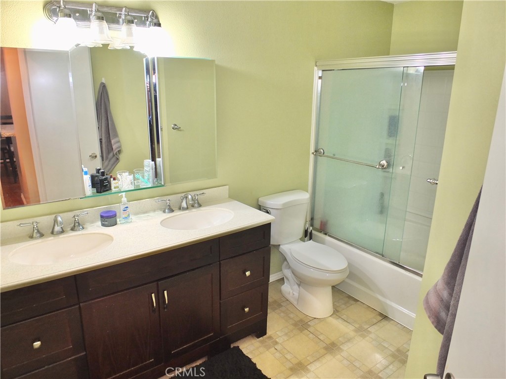 19431 Rue De Valore, Unit 19B Lake Forest, CA 92610 - Photo 12 of 24 a bathroom with a toilet sink and mirror