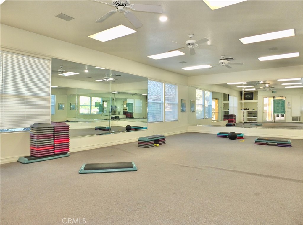 19431 Rue De Valore, Unit 19B Lake Forest, CA 92610 - Photo 16 of 24 an open kitchen with kitchen island and stainless steel appliances