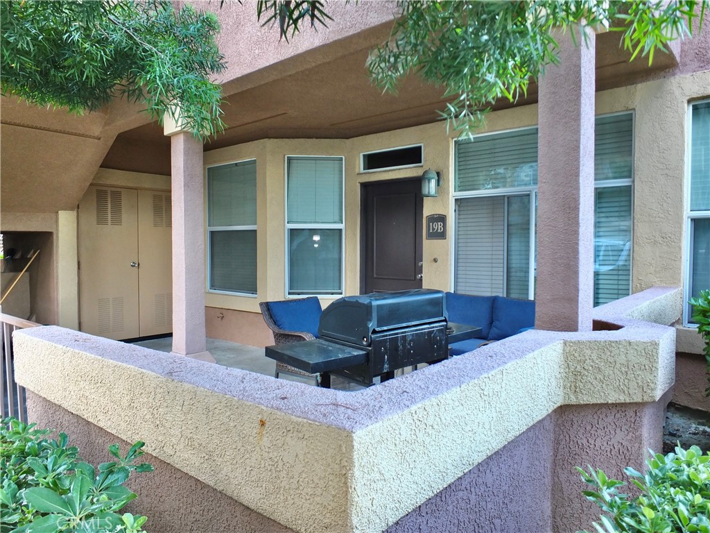 19431 Rue De Valore, Unit 19B Lake Forest, CA 92610 - Photo 2 of 24 a living room with a couch and trees