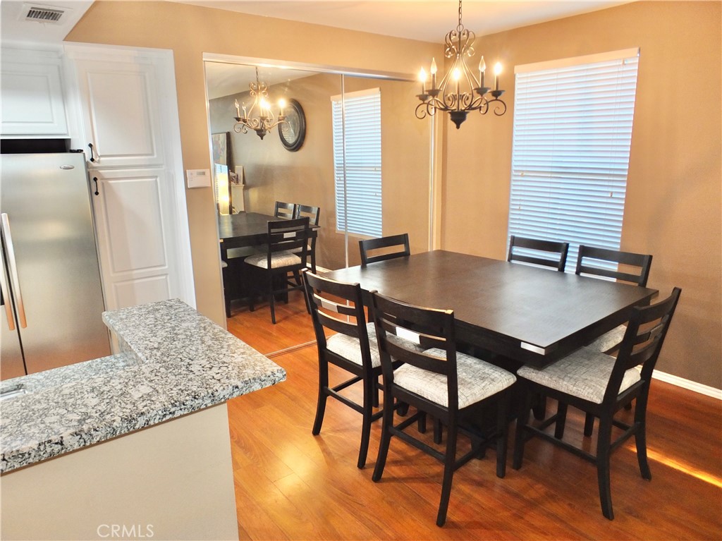 19431 Rue De Valore, Unit 19B Lake Forest, CA 92610 - Photo 8 of 24 a view of a dining room with furniture and a chandelier