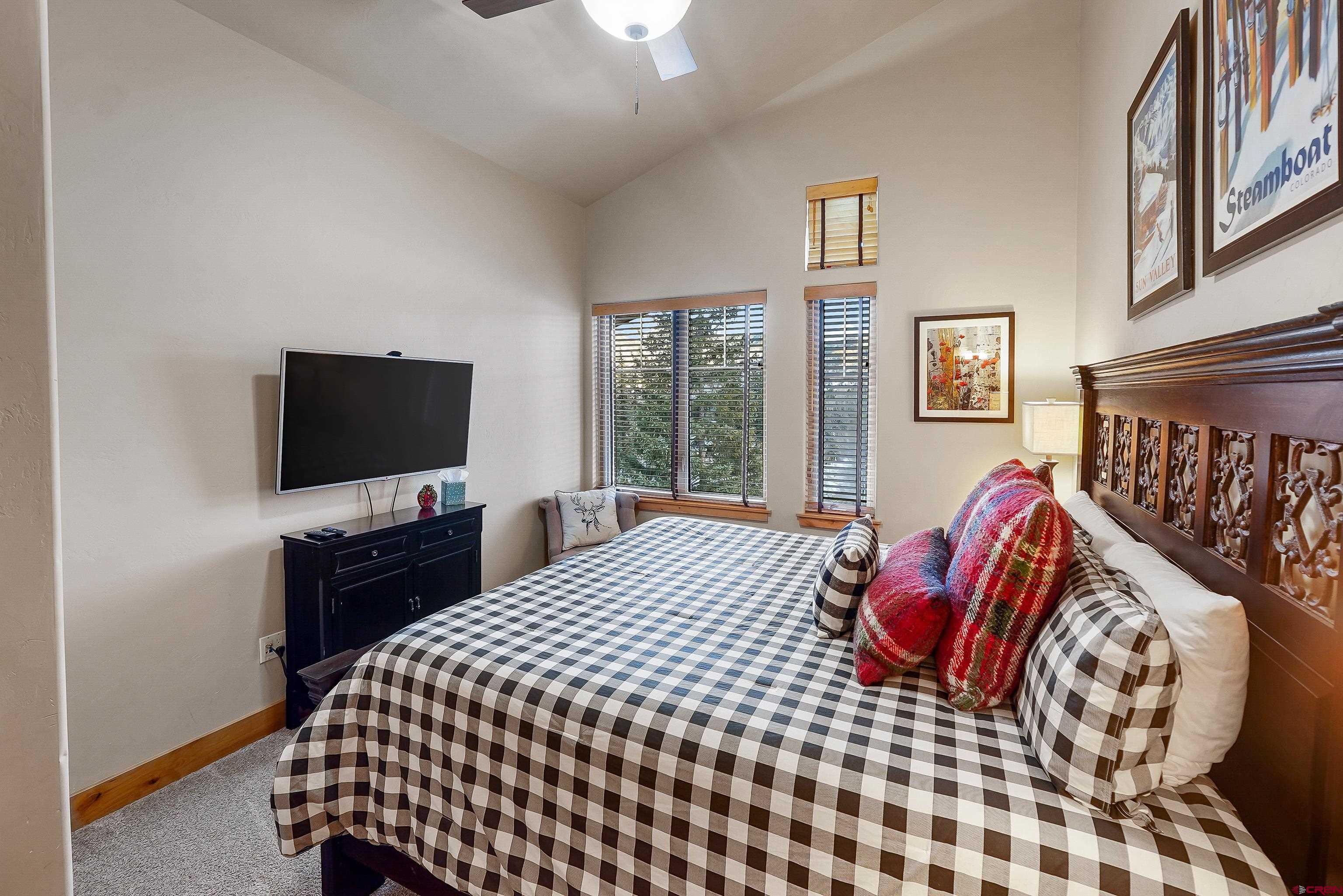 8 Summer Solstice Street Durango, CO 81301 - Photo 17 of 45 a bedroom with a bed and a flat screen tv