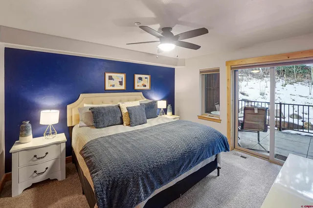 a bathroom with a granite countertop toilet sink a mirror and shower curtain