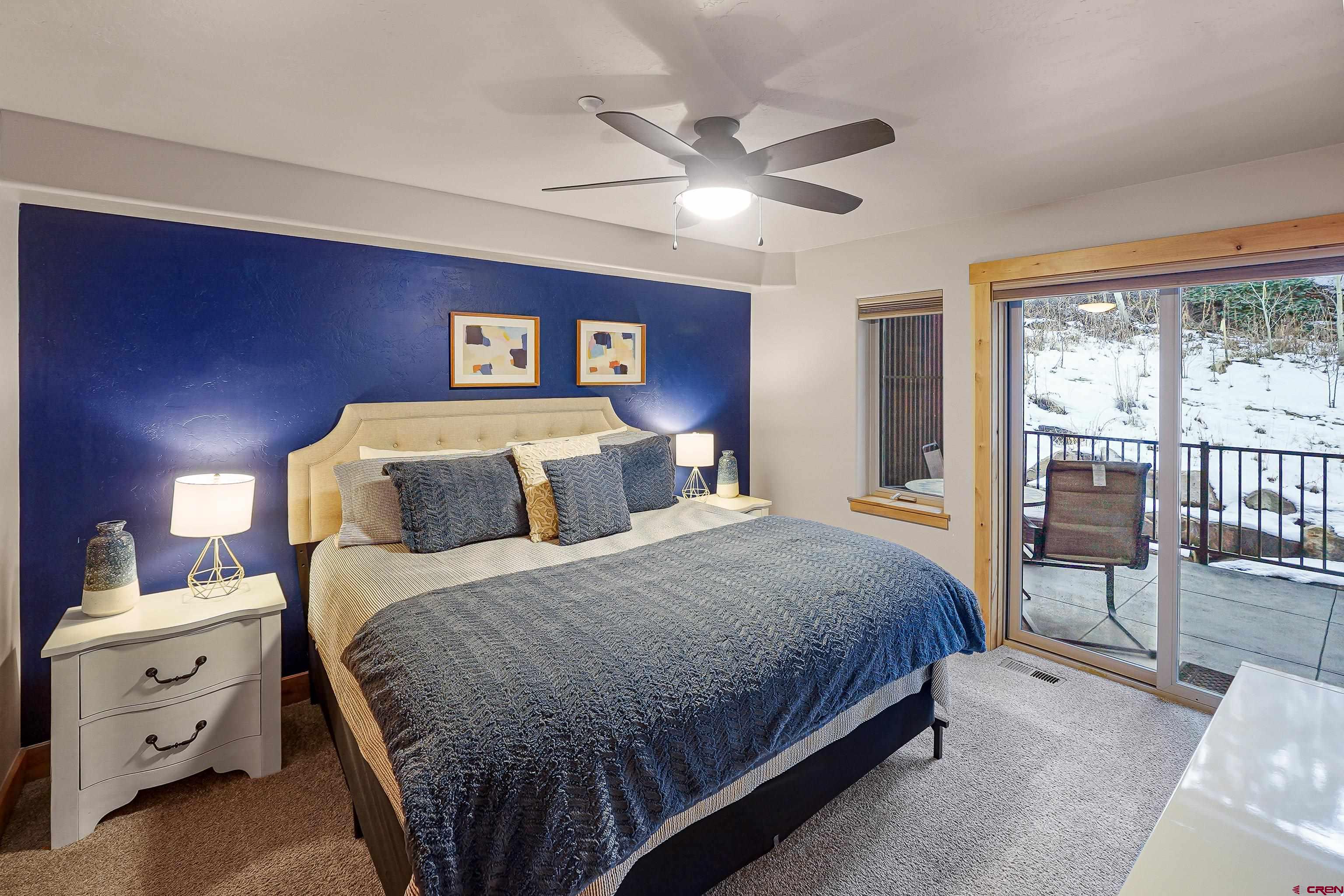 8 Summer Solstice Street Durango, CO 81301 - Photo 20 of 45 a bedroom with a bed and a chandelier