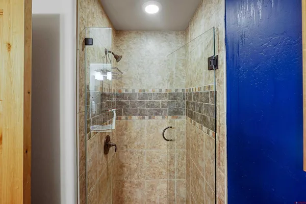 a bedroom with furniture and a flat screen tv