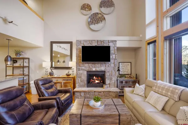 a living room with furniture and a fireplace