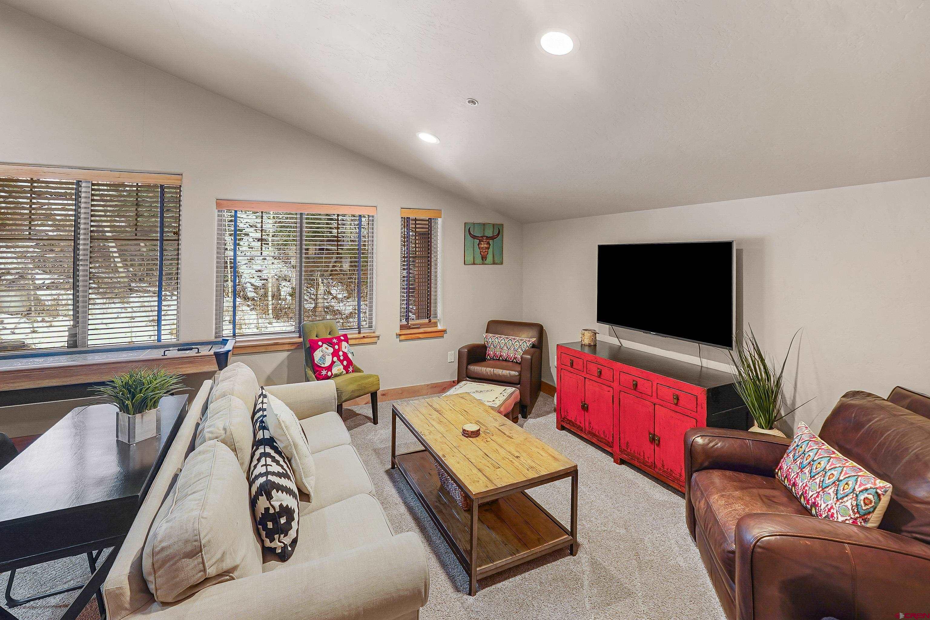 8 Summer Solstice Street Durango, CO 81301 - Photo 31 of 45 a living room with furniture and a flat screen tv