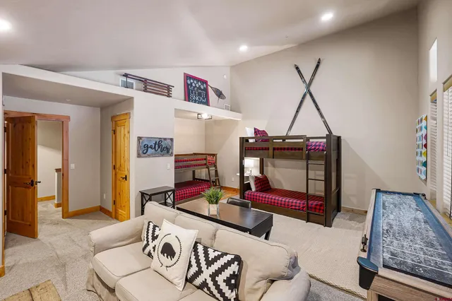 a living room with furniture and floor to ceiling windows