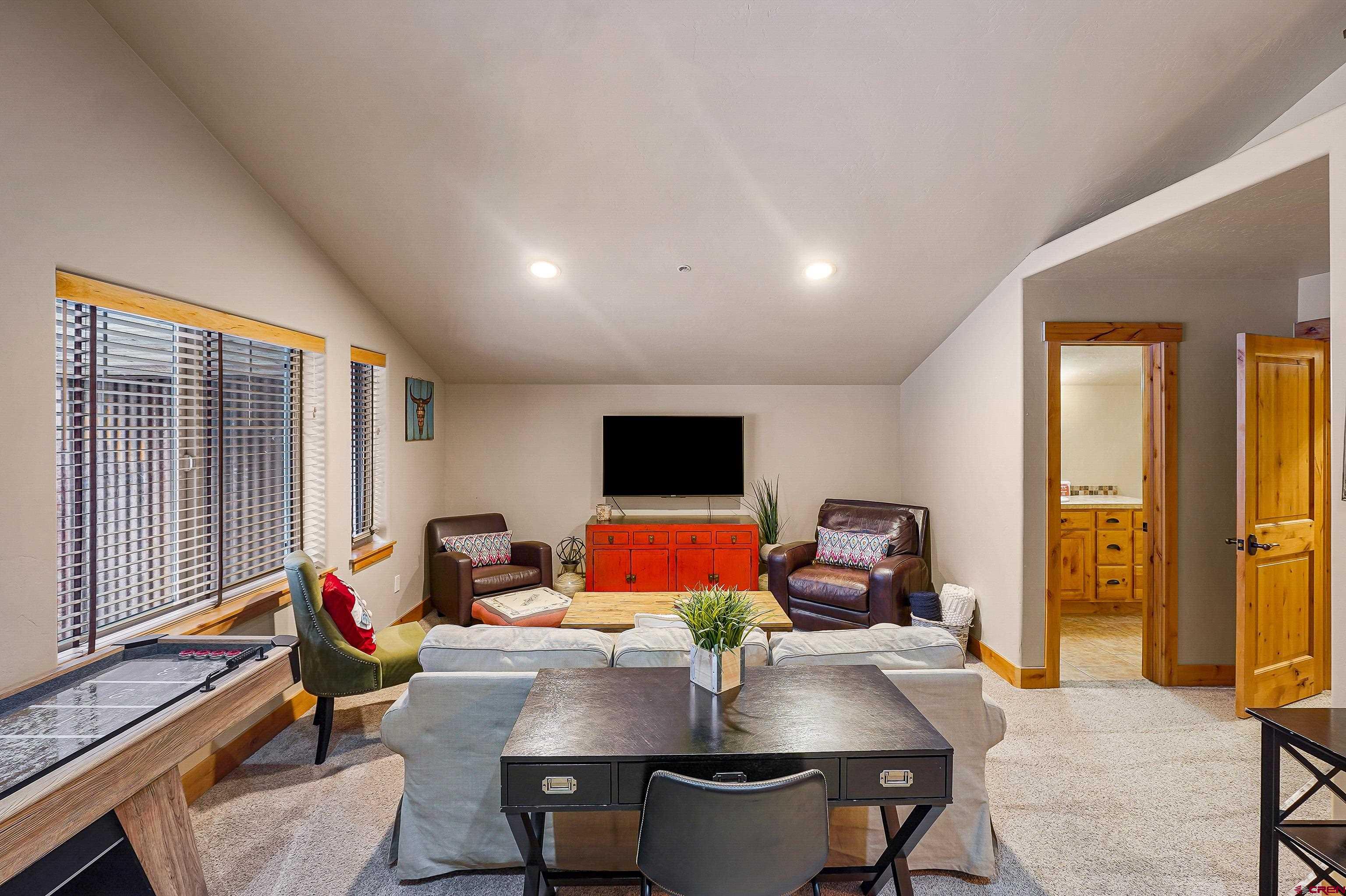 8 Summer Solstice Street Durango, CO 81301 - Photo 33 of 45 a living room with furniture and floor to ceiling windows