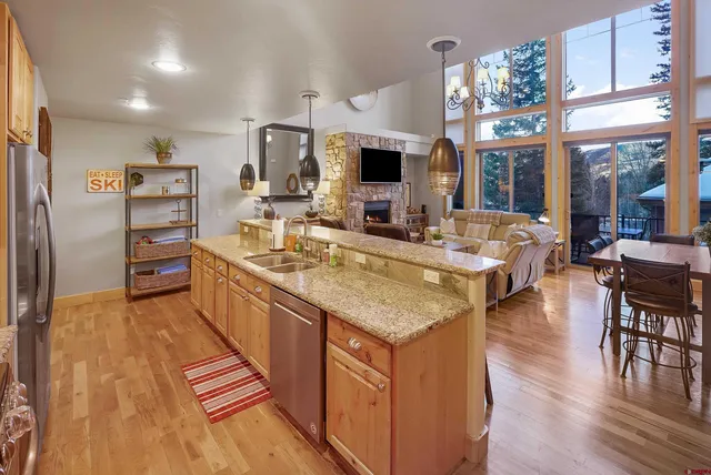 a kitchen with cabinets and wooden floor