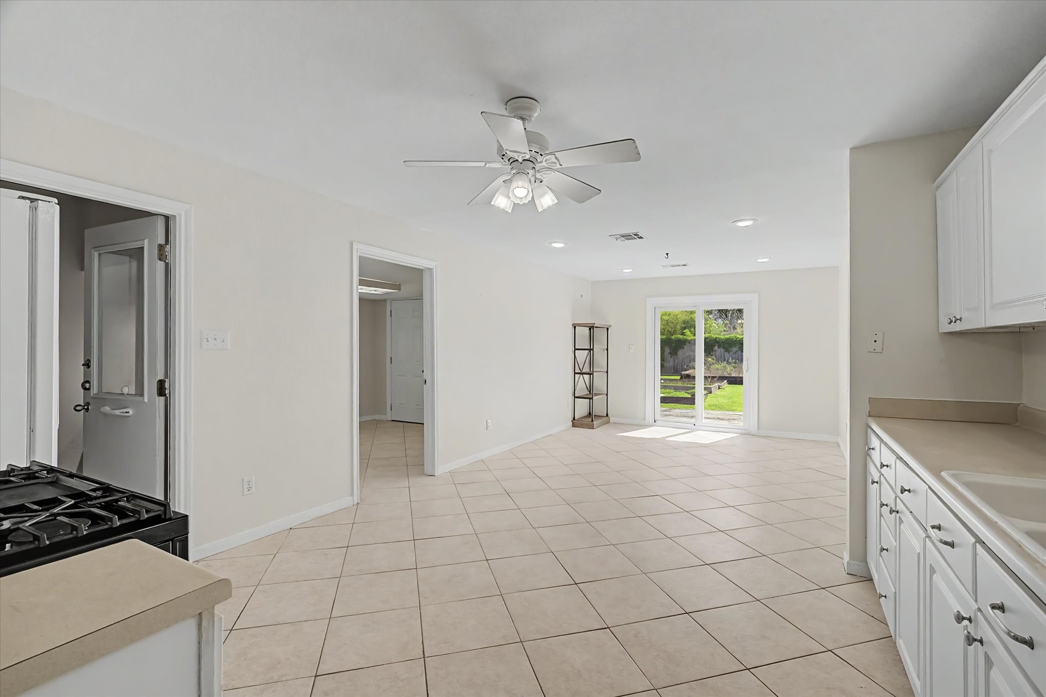 413 Farrer Street Angleton, TX 77515 - Photo 10 of 43 a view of an empty room and window and cabinet