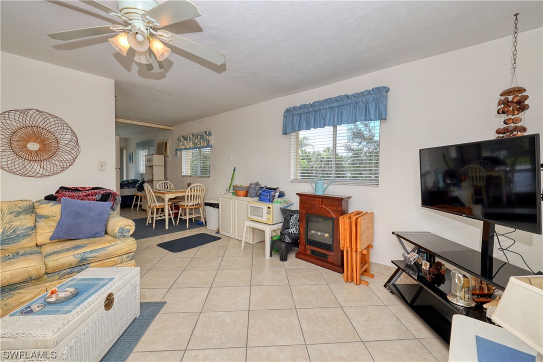 8109 Country Road, Unit 202 Fort Myers, FL 33919 - Photo 7 of 29 a living room with furniture and a flat screen tv