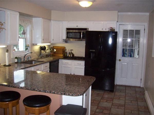 99 Westbrook Road Whately, MA 01373 - Photo 7 of 29 a kitchen with a sink a stove and refrigerator