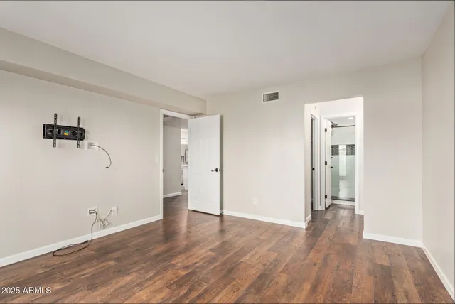 a view of an empty room with wooden floor
