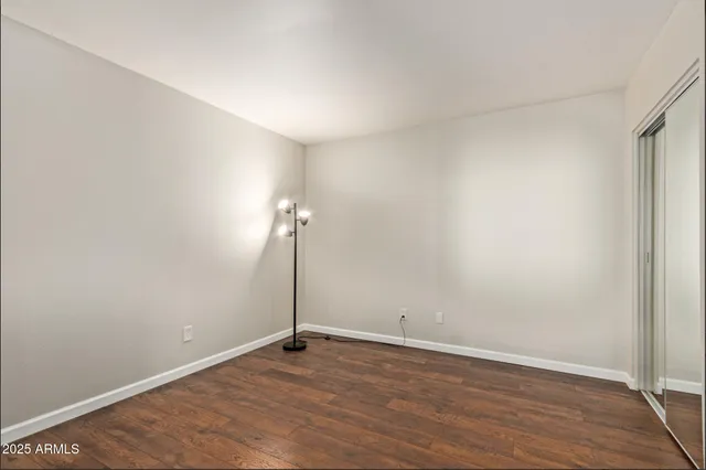 an empty room with wooden floor