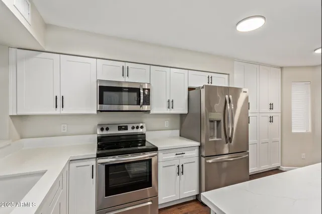a kitchen with a refrigerator stove and microwave