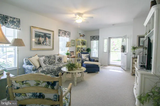 a living room with furniture a fireplace and a chandelier