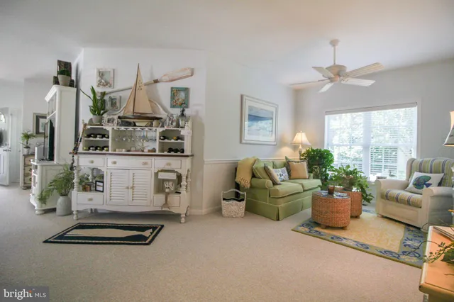 a kitchen with stainless steel appliances granite countertop a refrigerator a sink dishwasher a stove and white cabinets with wooden floor