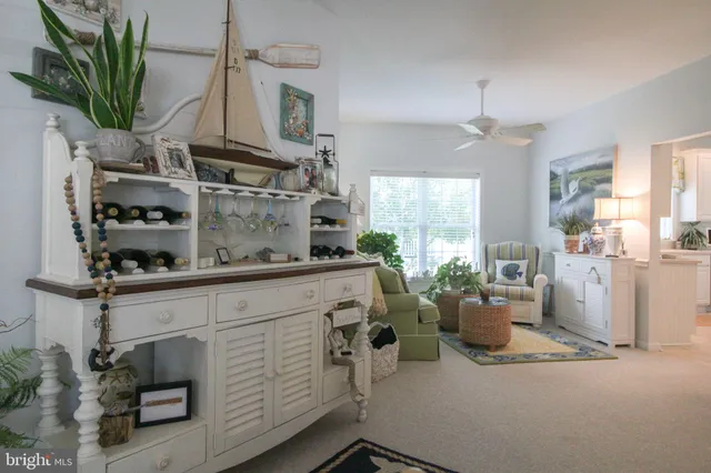 a living room with kitchen island furniture and a chandelier