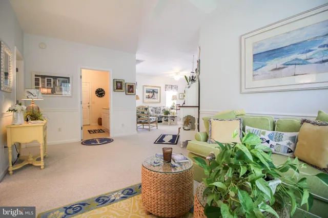 a living room with patio furniture and a floor to ceiling window