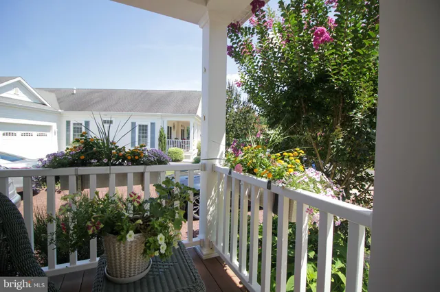 a front view of house with outdoor seating and plants