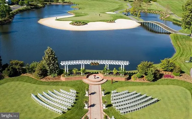 a view of a lake with a table and chairs