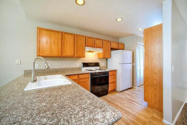 a kitchen with a refrigerator sink and stove